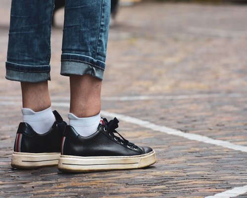 Close up of comfortable sneakers on an urban pavement