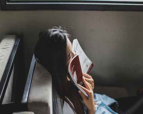 Person relaxing on a couch reading